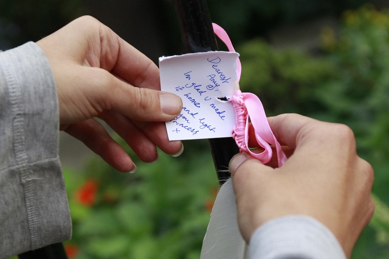 Image: An Amy Winehouse fan puts a note outside her home in London